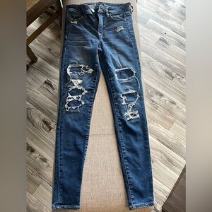 Dark XS (00) ripped, skinny blue jeans from American eagle for girls.